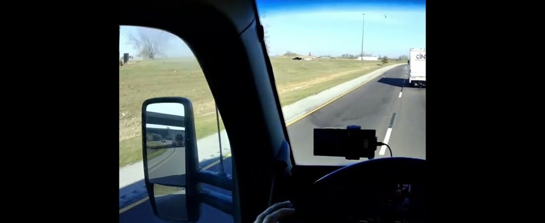 POV Inside of a moving semi truck driving on the highway fully loaded. (3)