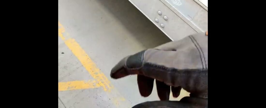 Truck Driver Demonstrates How to properly remove a Tire Lock from a Loaded Semi Trailer