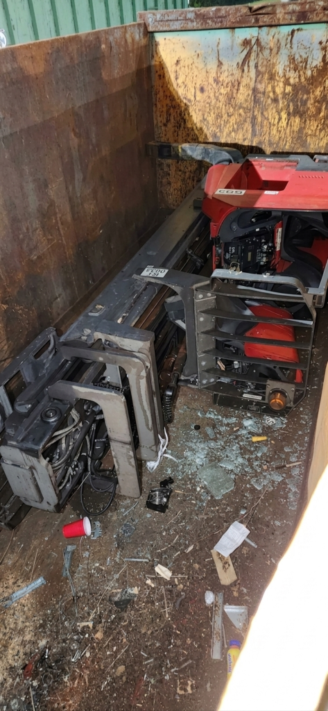 DISGRUNTLED DOCK WORKER DROVE HIS FORKLIFT INTO THE DUMPSTER BEFORE QUITTING HIS JOB.